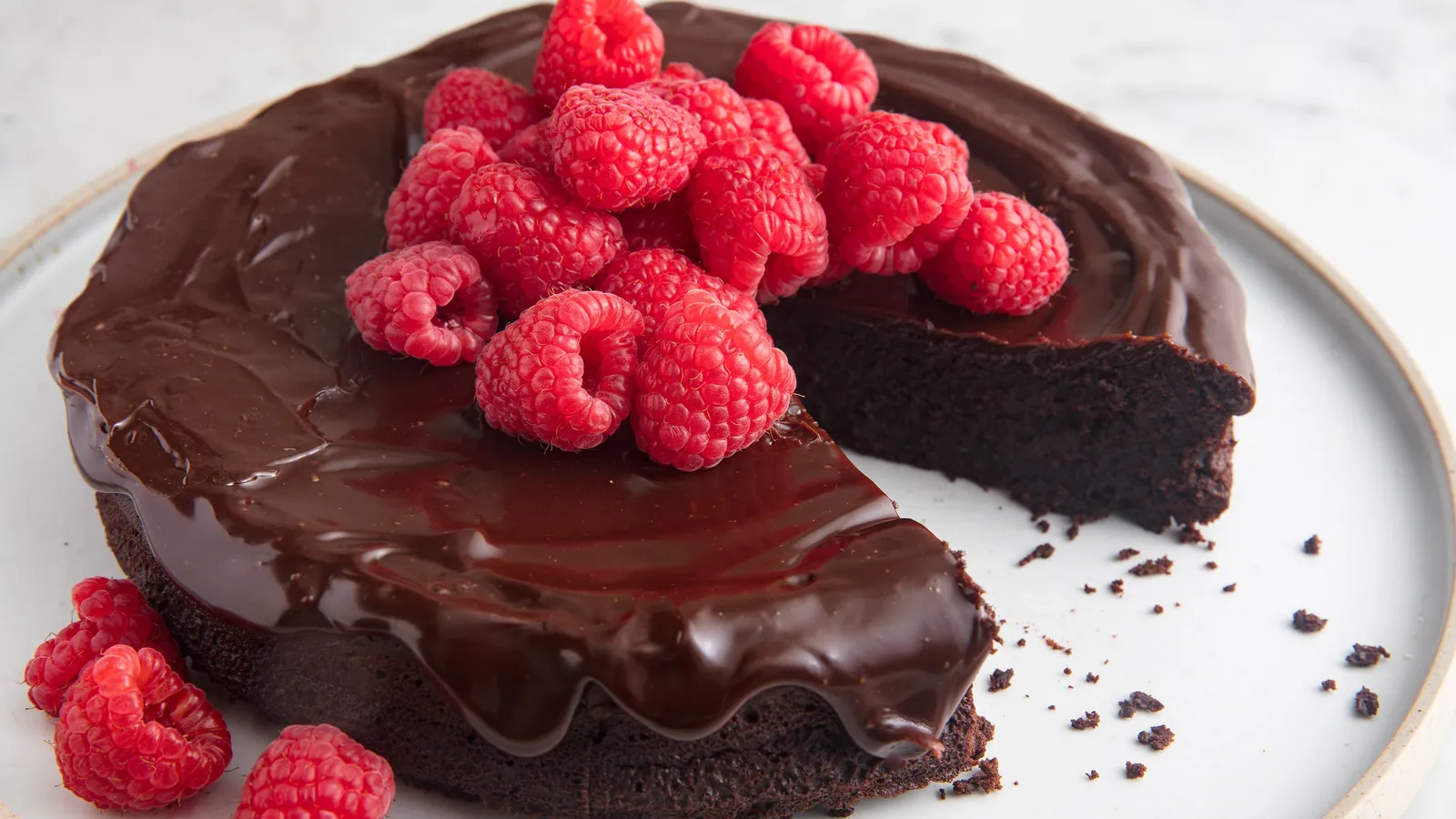 Glänzender Schokoladenkuchen mit Himbeeren